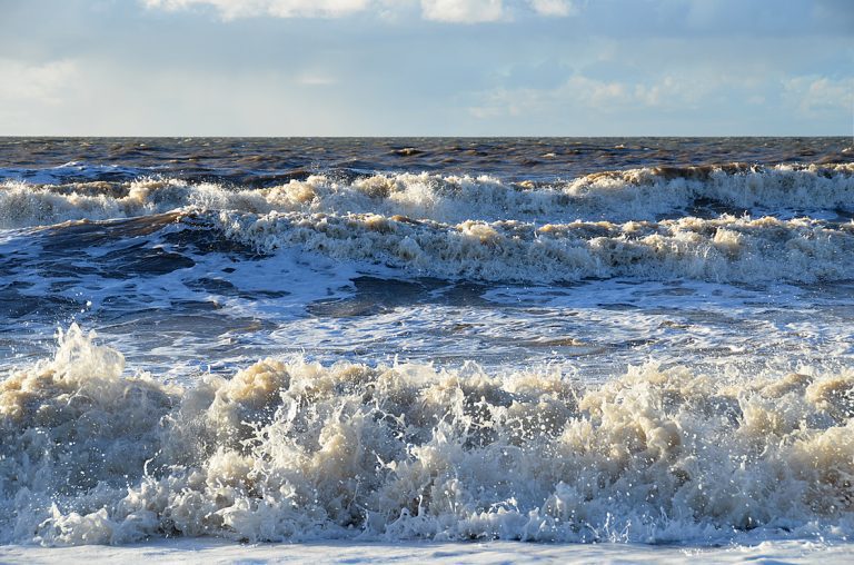 Jigsaw of splashy waves in sunshine