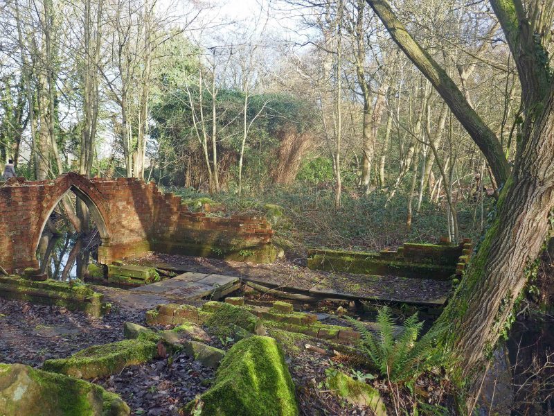 Remains of the old boathouse (scheduled for restoration) crumbling into the Lily Pond in Lytham Hall's extensive woodland.