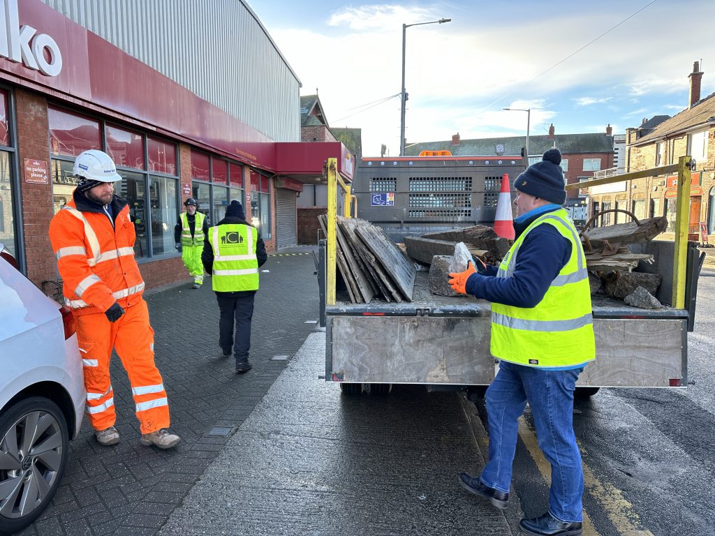 Unloading the old groyne boards and rock pieces donated