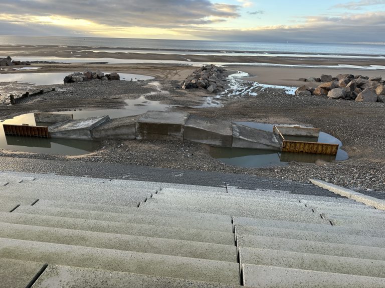 Yellow metal boxes still in place while concrete sets. Forming a crossover ramp