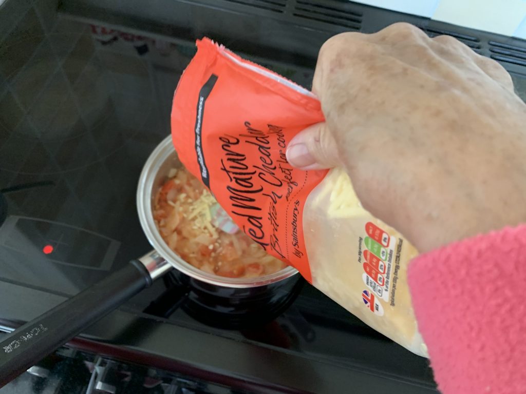 Add cheese to your bits and bobs on toast mixture