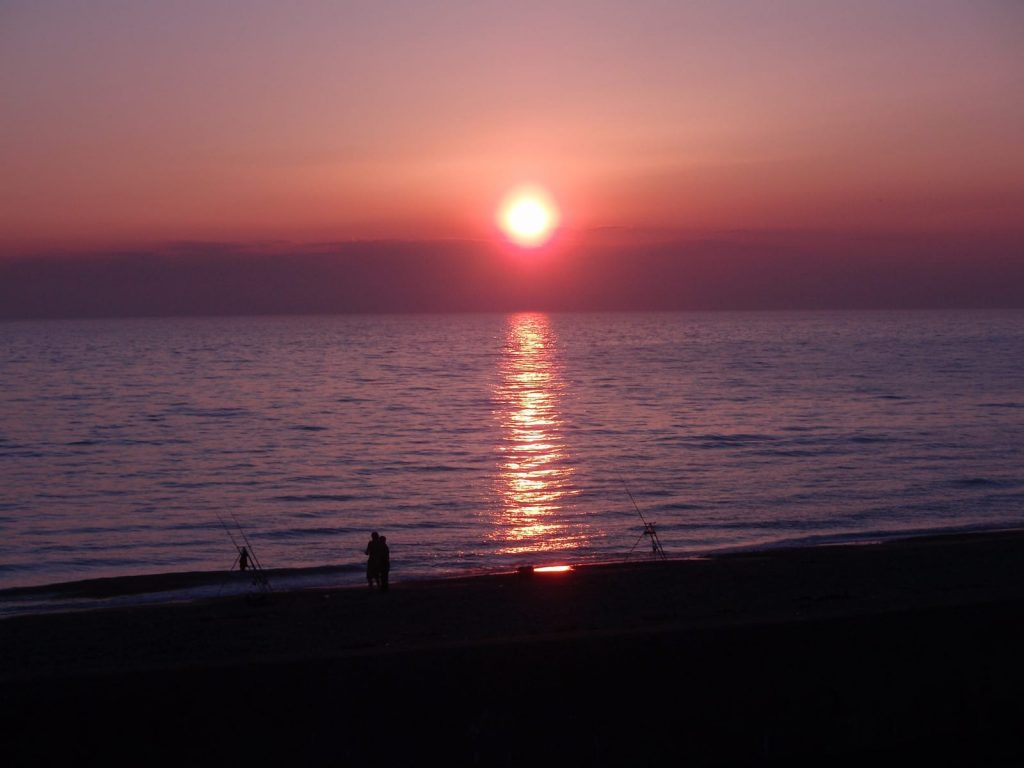 Sunsets over the sea through volcano dust